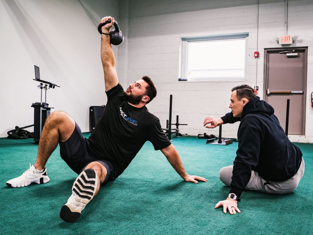 Client doing a shoulder exercise during one on one physical therapy at Next Level Physical Therapy in Southampton, PA