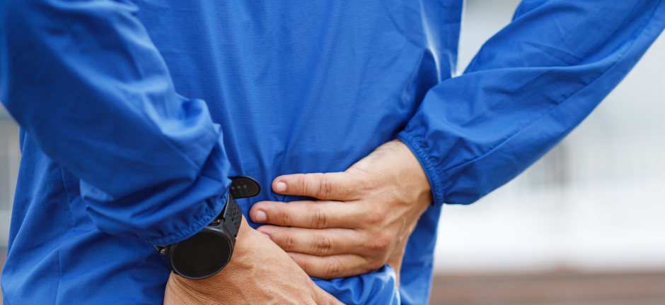Man holding his back from sciatica pain after exercise