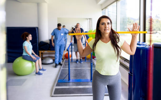 Woman doing physical therapy exercises alone using a stick while recovering from an injury