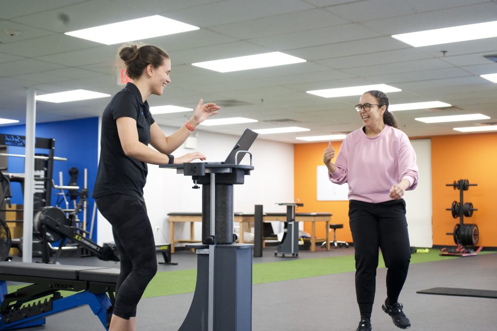 Client and physical therapist celebrating a win during one on one physical therapy at Next Level Physical Therapy in Marlton, NJ