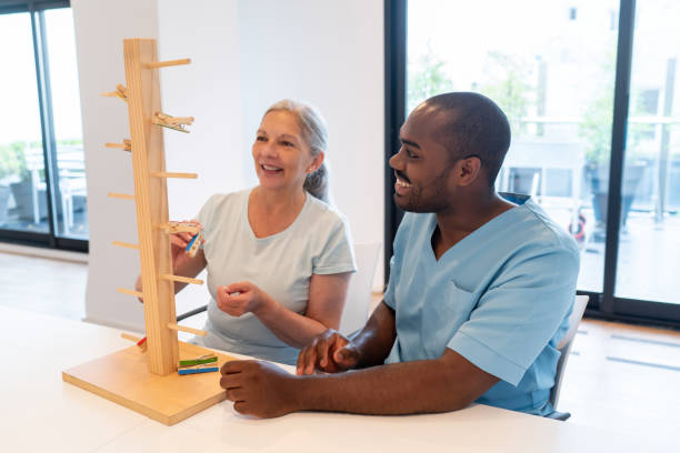 Occupational therapist working with a patient using a wooden tool with clothespins