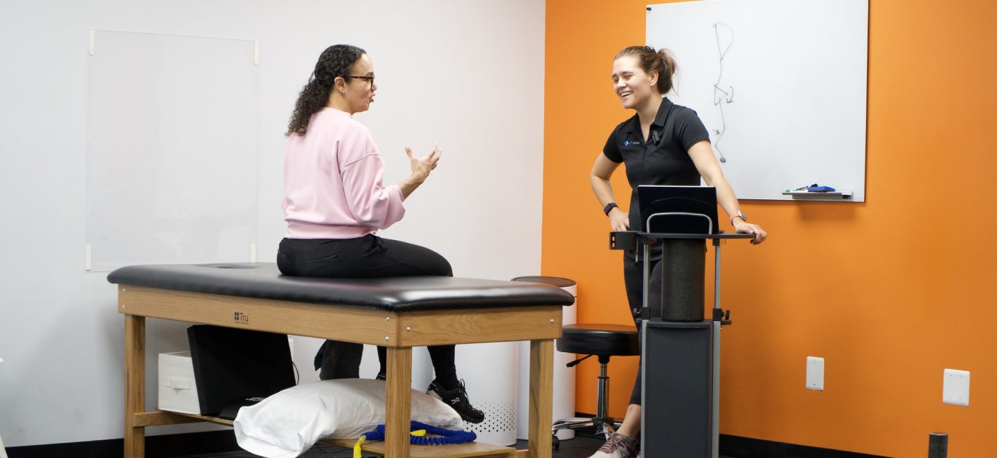 Physical therapist speaking with a client at Next Level Physical Therapy in Marlton, NJ