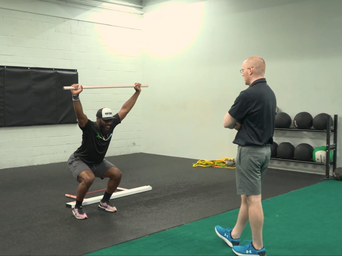 Dr. Mike Assessing Functional Movement Screen Patient as they perform a basic movement screen