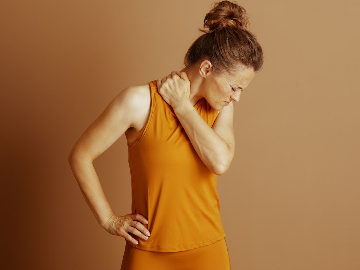 FRUSTRATED ACTIVE ADULT HOLDING SHOULDER