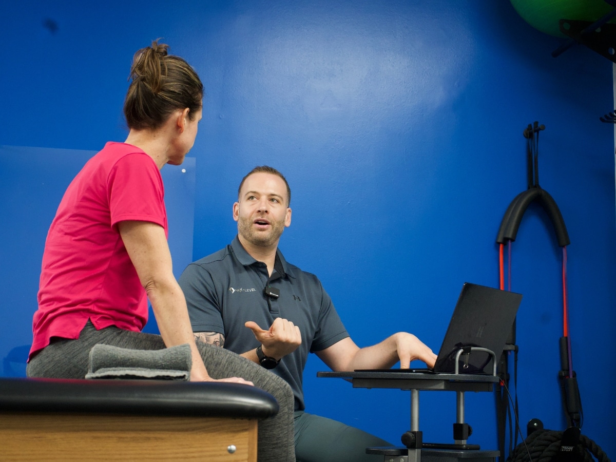 Next Level Physical Therapy Dr. Leor Assisting Client with Backpain