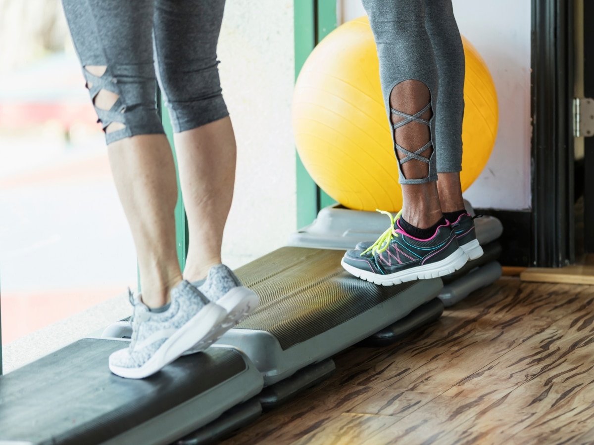 ATHLETE PERFORMING A CONTROLLED TENDON LOADING EXERCISE SLOW HEAVY CALF RAISE