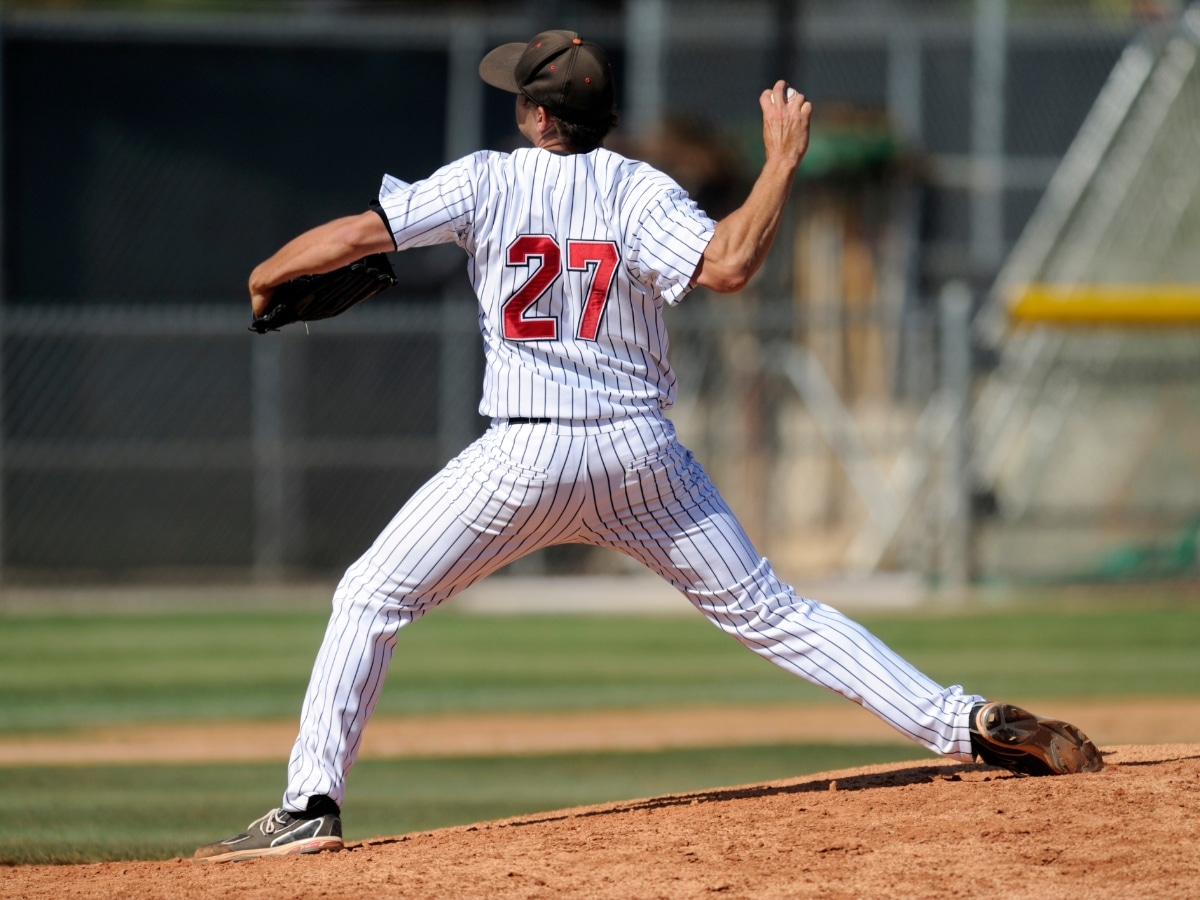 BASEBALL PITCHER IN LATE THROWING POSITION WITH EMPHASIS ON SHOULDER ROTATION