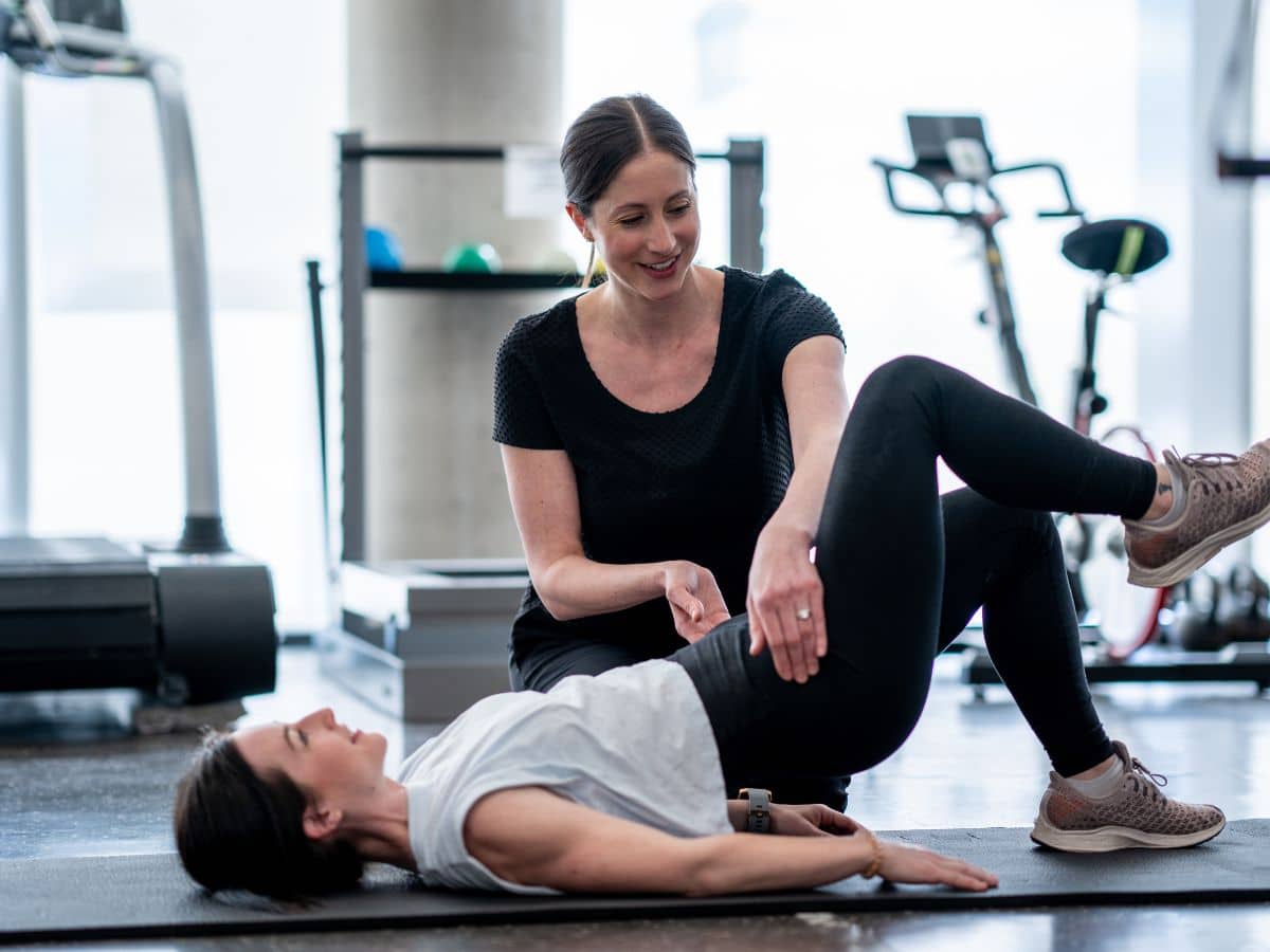PHYSICAL THERAPIST COACHING PATIENT THROUGH PELVIC POSITIONING EXERCISE